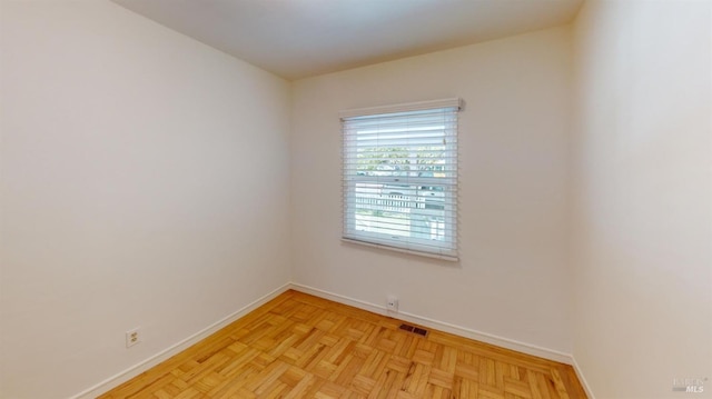 unfurnished room with light parquet flooring