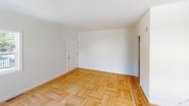 unfurnished room featuring light parquet floors