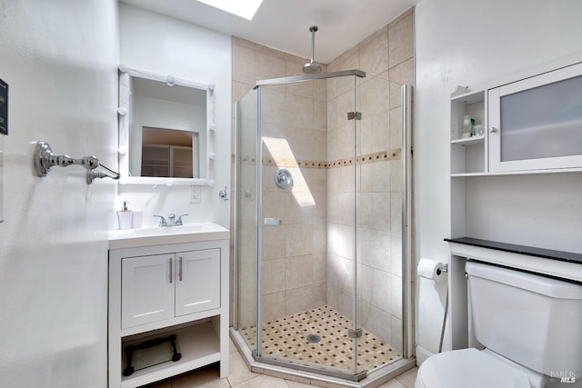 bathroom featuring toilet, vanity, and a shower with shower door