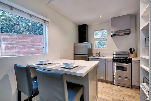 kitchen featuring appliances with stainless steel finishes, sink, gray cabinetry, and light stone counters