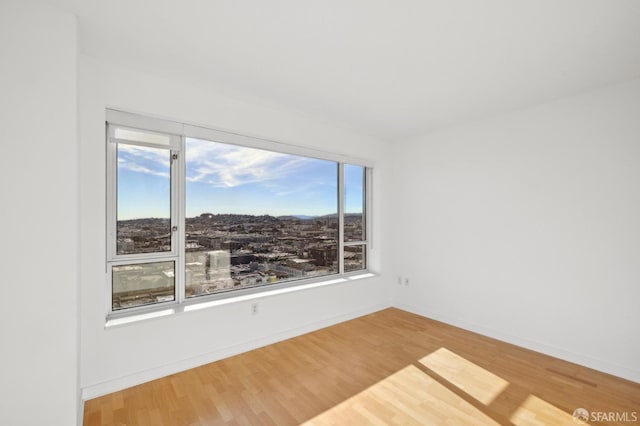 unfurnished room featuring hardwood / wood-style floors