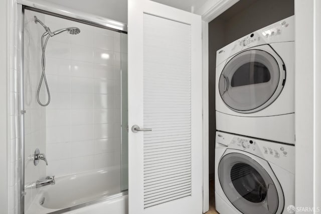 clothes washing area featuring stacked washer / drying machine