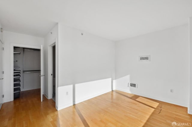 spare room with hardwood / wood-style floors