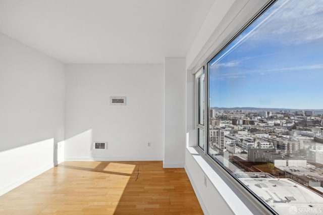 unfurnished room featuring light hardwood / wood-style floors