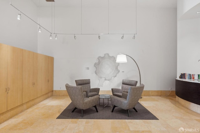 sitting room featuring light tile patterned floors and track lighting