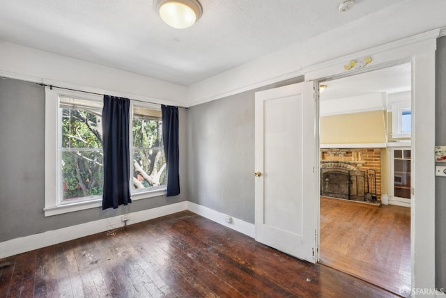 2714 Diamond St, San Francisco, CA 94131 - unfurnished room featuring a fireplace with raised hearth, hardwood / wood-style flooring, baseboards, and a smoke detector