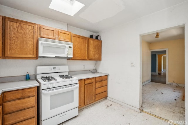 2714 Diamond St, San Francisco, CA 94131 - kitchen with white appliances, a skylight, light flooring, light countertops, and brown cabinetry