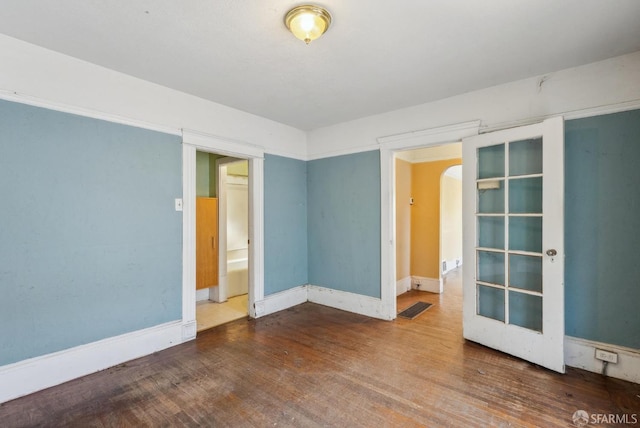 2714 Diamond St, San Francisco, CA 94131 - unfurnished room with wood finished floors, arched walkways, and baseboards