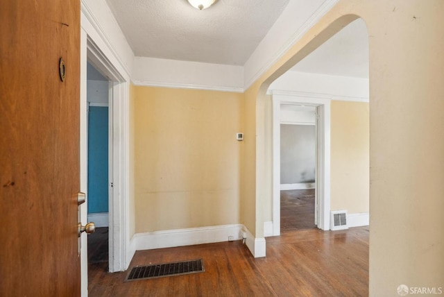 2714 Diamond St, San Francisco, CA 94131 - foyer with arched walkways, wood finished floors, and baseboards