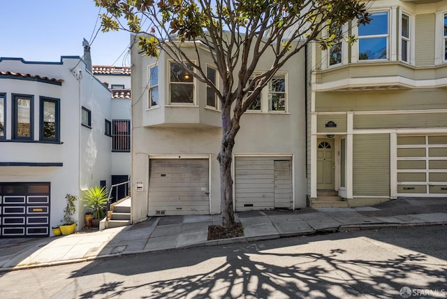 2714 Diamond St, San Francisco, CA 94131 - townhome / multi-family property with an attached garage, stucco siding, and concrete driveway