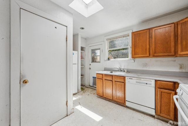 2714 Diamond St, San Francisco, CA 94131 - kitchen featuring white appliances, a skylight, a sink, light countertops, and light flooring