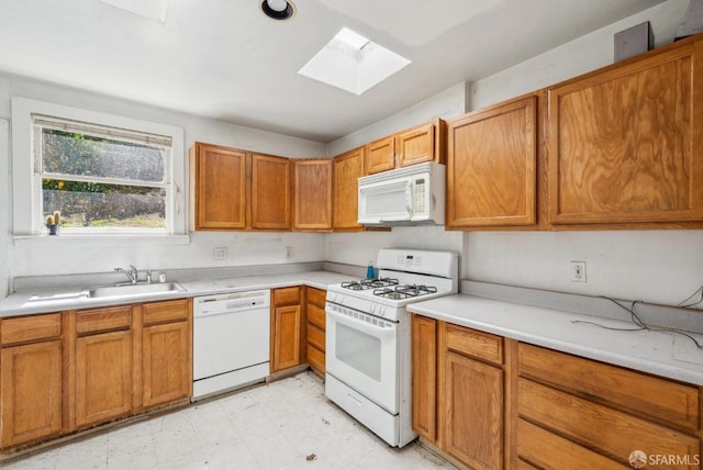 2714 Diamond St, San Francisco, CA 94131 - kitchen with white appliances, a skylight, a sink, light flooring, and light countertops