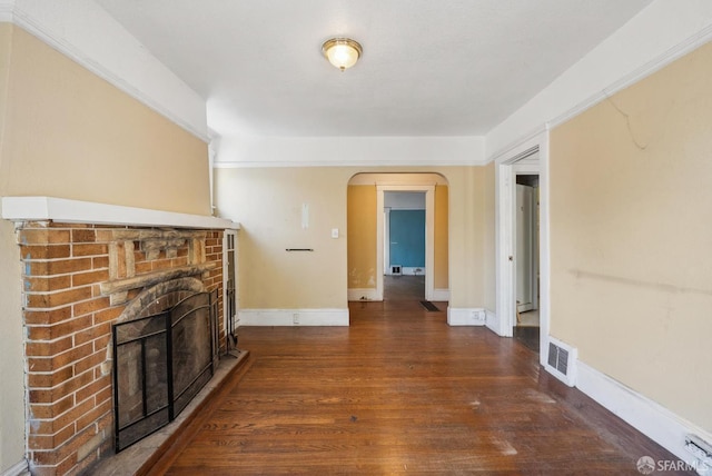 2714 Diamond St, San Francisco, CA 94131 - unfurnished living room featuring arched walkways, a brick fireplace, wood finished floors, and baseboards