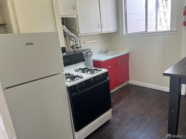 19 Moss St, San Francisco, CA 94103 - kitchen with gas range oven, freestanding refrigerator, dark wood-type flooring, a sink, and baseboards