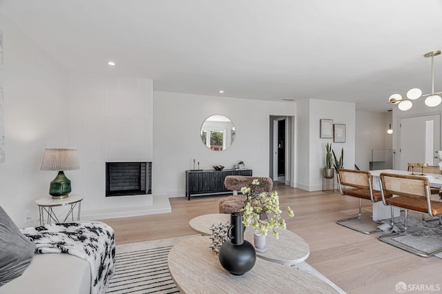 115 Gladeview Way, San Francisco, CA 94131 - living area featuring light wood finished floors, baseboards, a chandelier, recessed lighting, and a fireplace