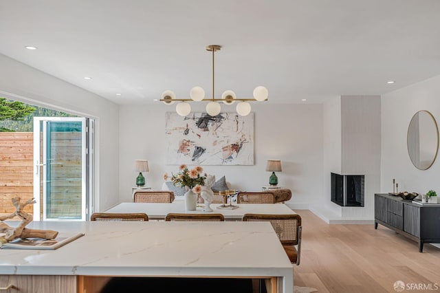 115 Gladeview Way, San Francisco, CA 94131 - dining room featuring light wood-style floors, a multi sided fireplace, recessed lighting, and baseboards