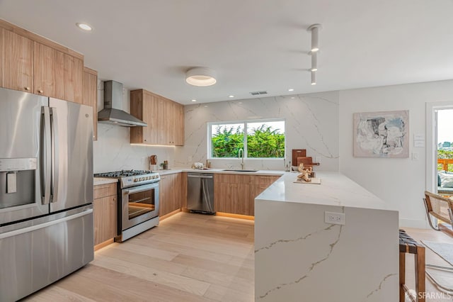 115 Gladeview Way, San Francisco, CA 94131 - kitchen with appliances with stainless steel finishes, wall chimney range hood, a sink, a peninsula, and light stone countertops