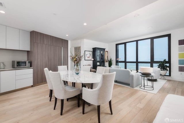 dining space with recessed lighting, visible vents, and light wood-style flooring