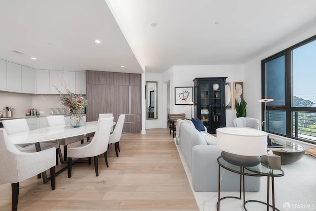dining room with recessed lighting, light wood-style flooring, and visible vents