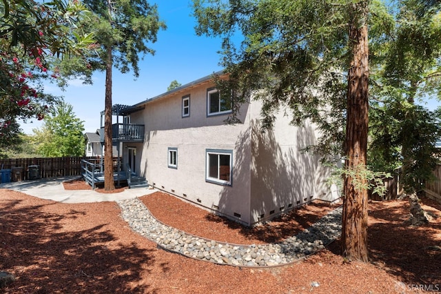 back of property featuring a balcony