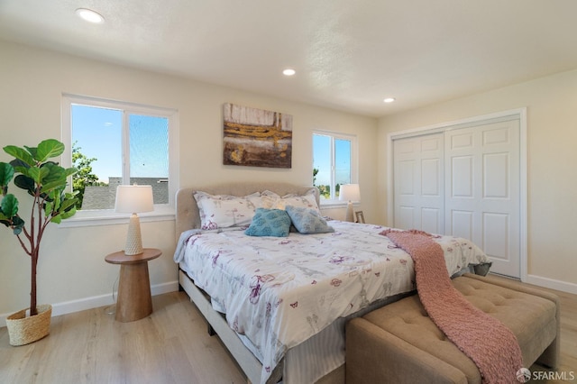 bedroom with a closet and light hardwood / wood-style floors