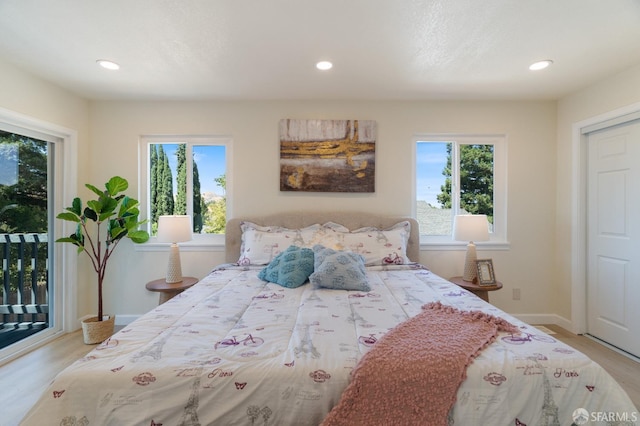 bedroom featuring access to outside and light hardwood / wood-style flooring