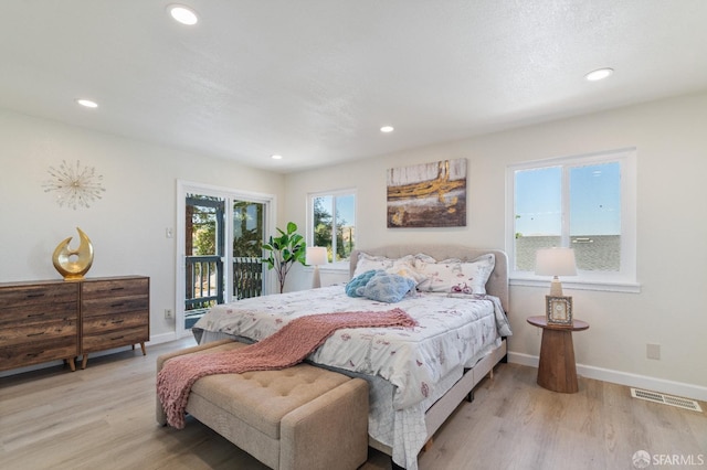 bedroom featuring access to outside and light hardwood / wood-style floors