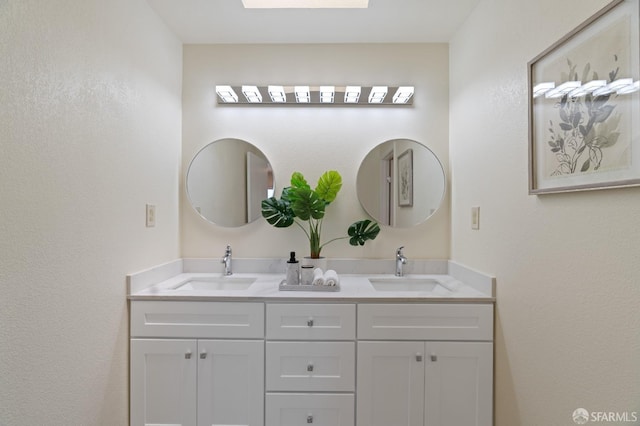 bathroom featuring vanity and a skylight