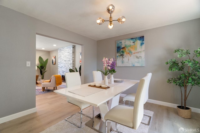 dining room with a chandelier and light hardwood / wood-style floors