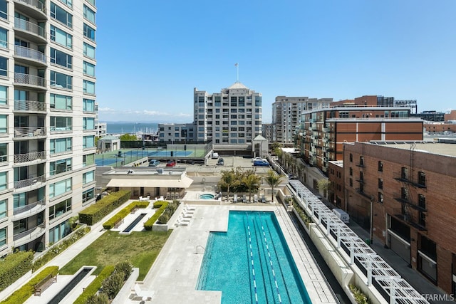 community pool with a city view and a water view