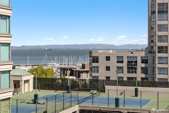water view featuring a mountain backdrop and fence