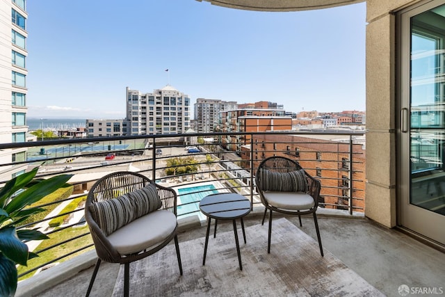 balcony featuring a view of city and view of pool area