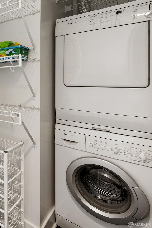 laundry area with stacked washer and clothes dryer