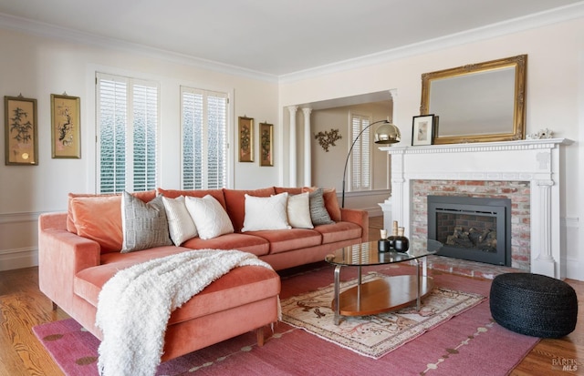 living room with a fireplace, hardwood / wood-style floors, and ornamental molding