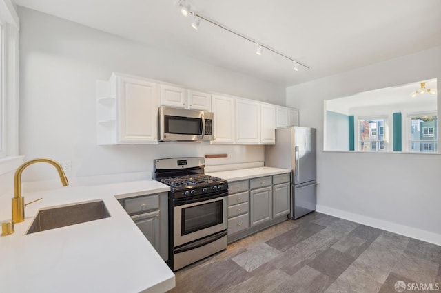 1930 Grove St Unit 4, San Francisco, CA 94117 - kitchen with appliances with stainless steel finishes, gray cabinets, rail lighting, and white cabinetry