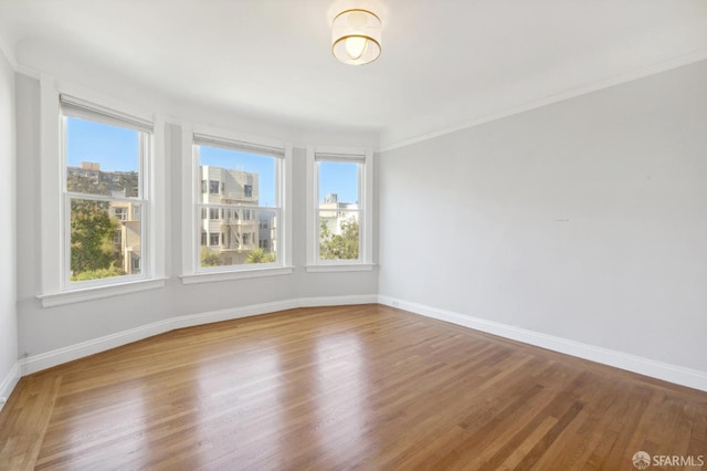 1930 Grove St Unit 4, San Francisco, CA 94117 - empty room featuring plenty of natural light, wood finished floors, and crown molding