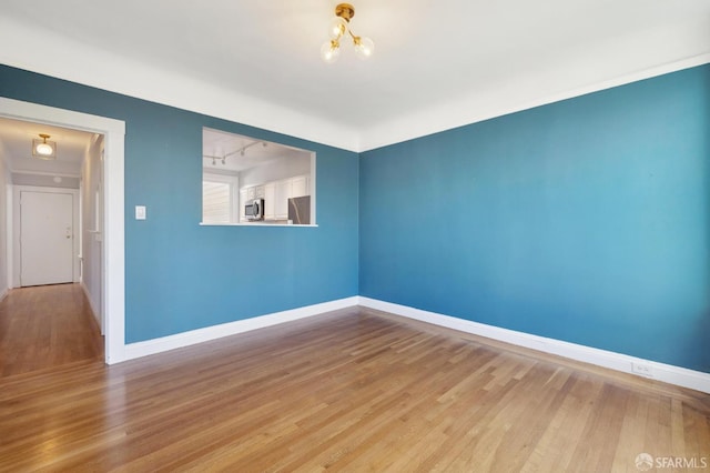1930 Grove St Unit 4, San Francisco, CA 94117 - spare room featuring wood finished floors and a chandelier