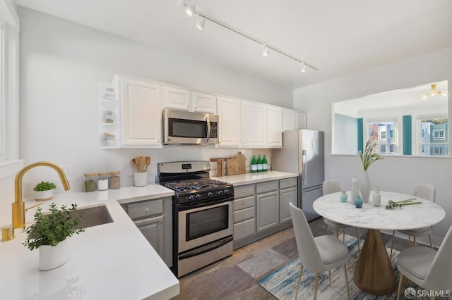 1930 Grove St Unit 4, San Francisco, CA 94117 - kitchen featuring stainless steel appliances, rail lighting, gray cabinetry, and white cabinets