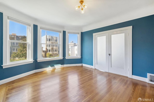 1930 Grove St Unit 4, San Francisco, CA 94117 - spare room with healthy amount of natural light, wood finished floors, and a chandelier