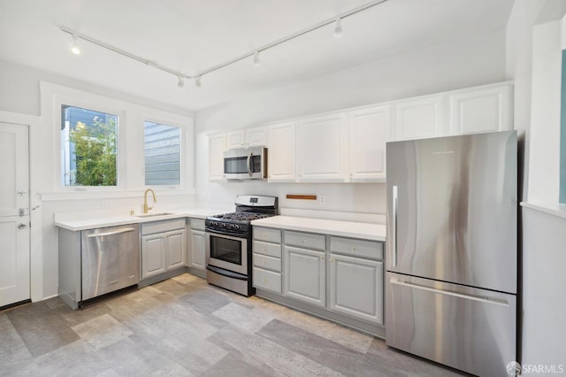 1930 Grove St Unit 4, San Francisco, CA 94117 - kitchen featuring stainless steel appliances, gray cabinetry, track lighting, and light countertops