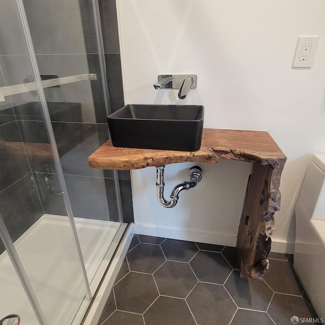939-9411/2 26th St, Oakland, CA 94601 - bathroom with a sink, tile patterned flooring, baseboards, and a stall shower