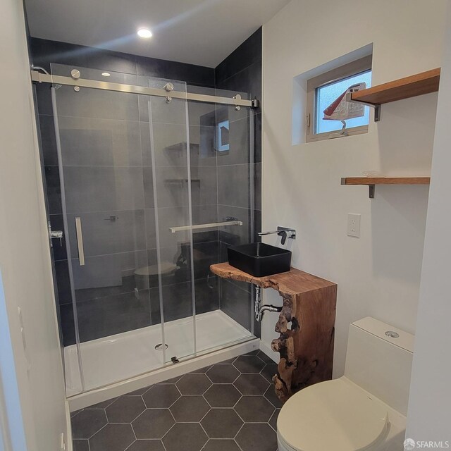 939-9411/2 26th St, Oakland, CA 94601 - bathroom with tile patterned floors, a stall shower, a sink, and toilet