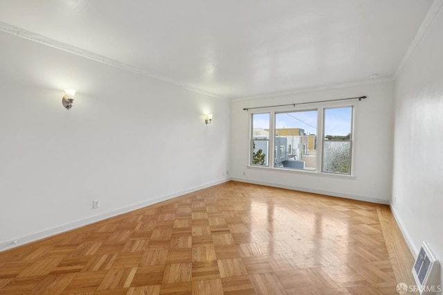 unfurnished room featuring ornamental molding, visible vents, and baseboards