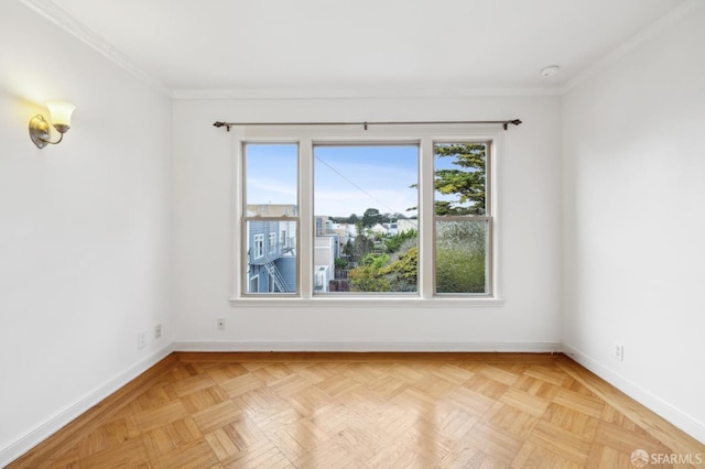 spare room featuring ornamental molding and baseboards