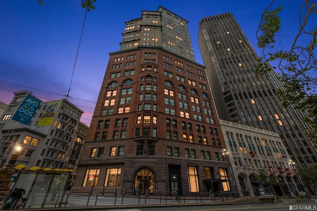 view of outdoor building at dusk