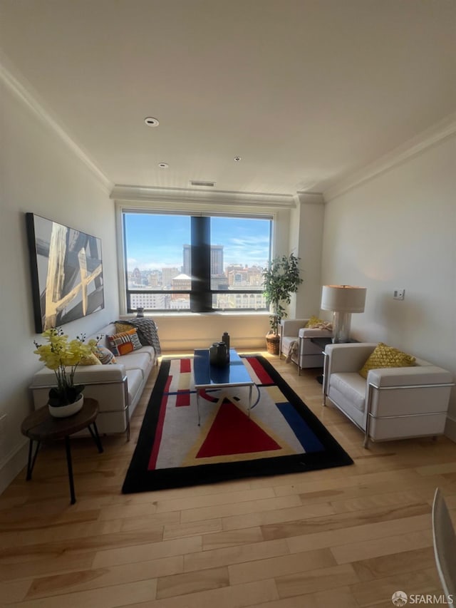 living room featuring light hardwood / wood-style flooring and crown molding