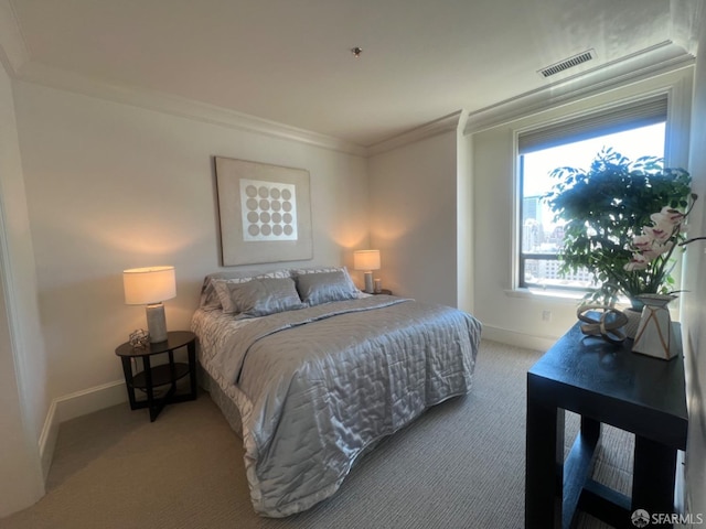 bedroom with ornamental molding and light carpet