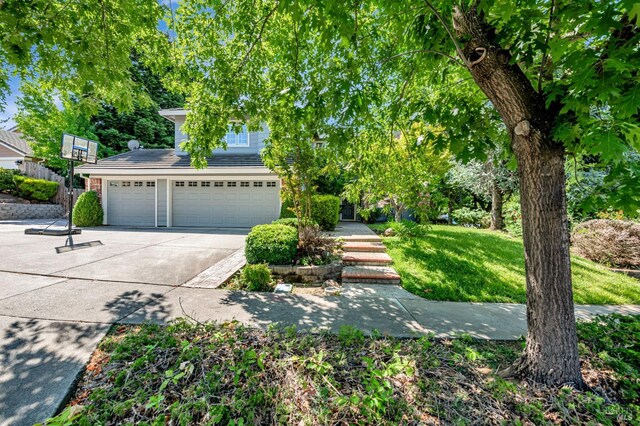 2035 Kirkwood Ct, Fairfield, CA 94534 - obstructed view of property featuring concrete driveway, a garage, and a front yard