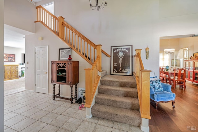 2035 Kirkwood Ct, Fairfield, CA 94534 - stairs featuring a towering ceiling, a chandelier, tile patterned floors, and baseboards