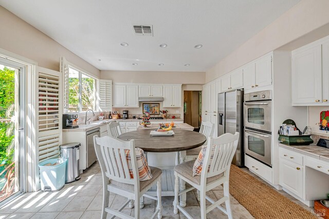 2035 Kirkwood Ct, Fairfield, CA 94534 - kitchen with appliances with stainless steel finishes, white cabinets, light countertops, light tile patterned floors, and a sink